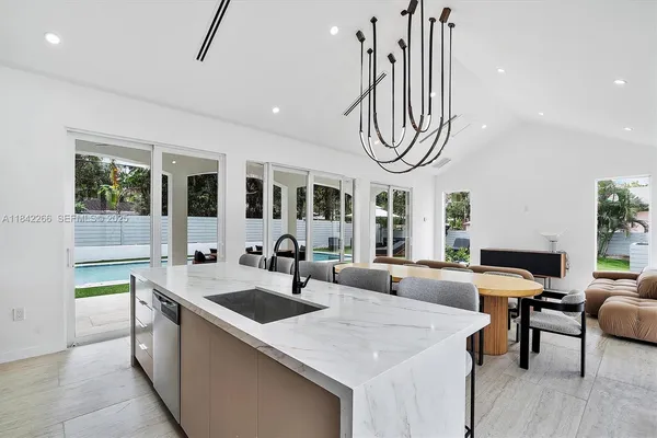 a very nice looking living room with a dining table chairs and couches