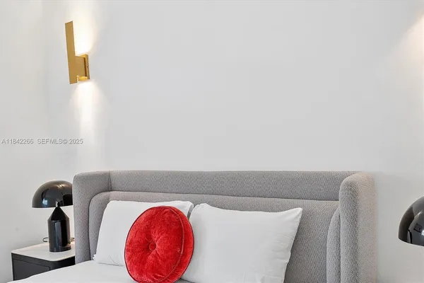 a living room with furniture a large window and a mirror