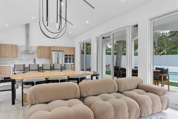 a kitchen with stainless steel appliances granite countertop a sink and a refrigerator