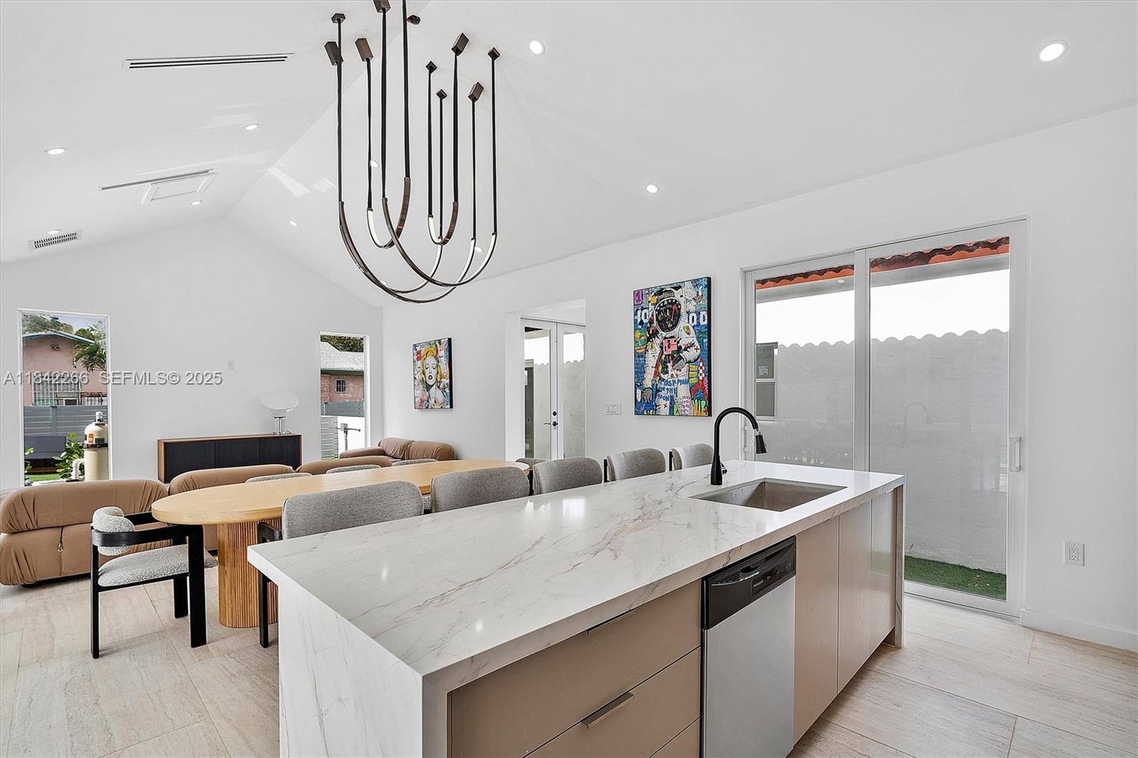 58 Northeast 45th Street Miami, FL 33137 - Photo 43 of 55 a living room with furniture a large window and a chandelier