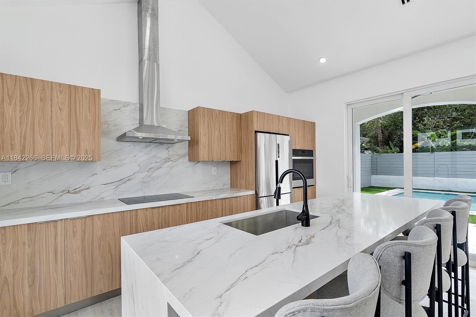58 Northeast 45th Street Miami, FL 33137 - Photo 45 of 55 a kitchen with stainless steel appliances granite countertop a sink and a refrigerator