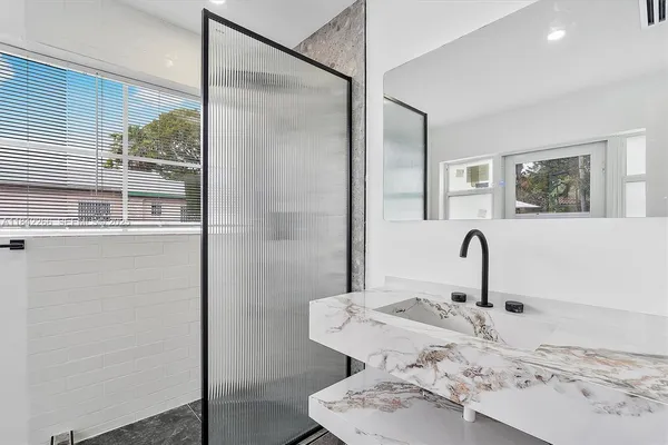 a very nice looking room with a glass door shower