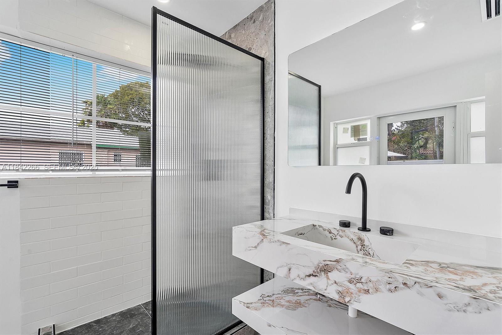 58 Northeast 45th Street Miami, FL 33137 - Photo 48 of 55 a bathroom with a sink and mirror