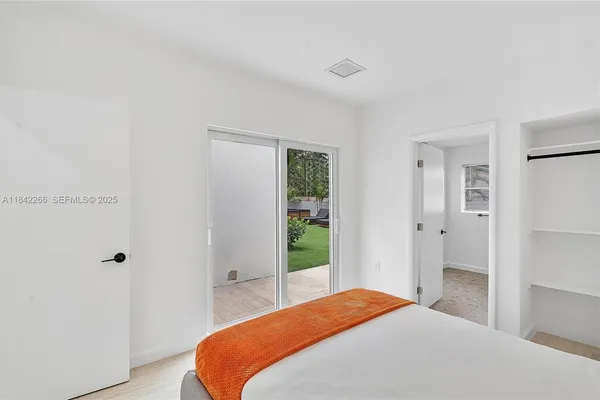 a bathroom with a painting on the wall and a shower