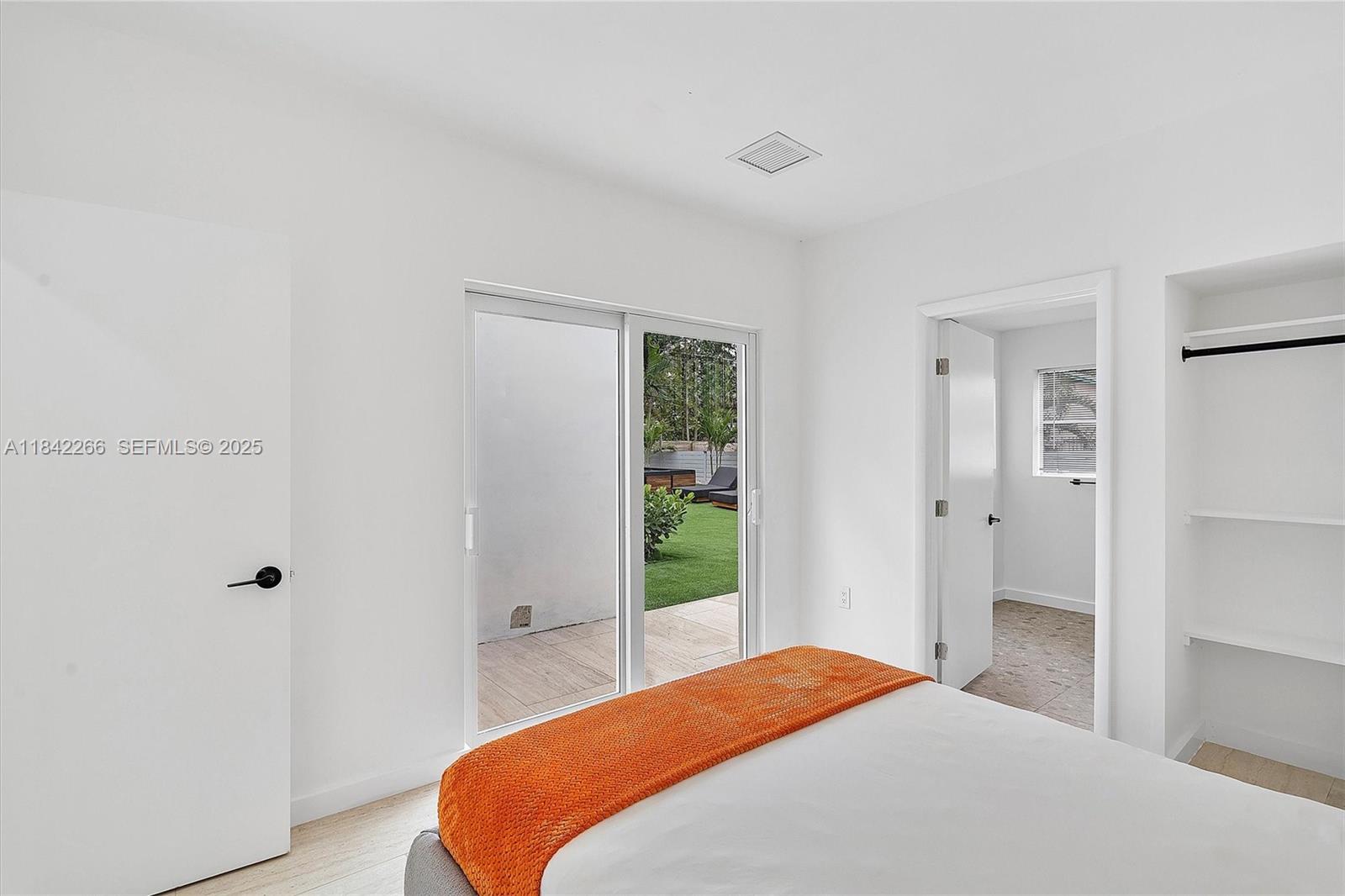 58 Northeast 45th Street Miami, FL 33137 - Photo 49 of 55 a bedroom with a bed and a window
