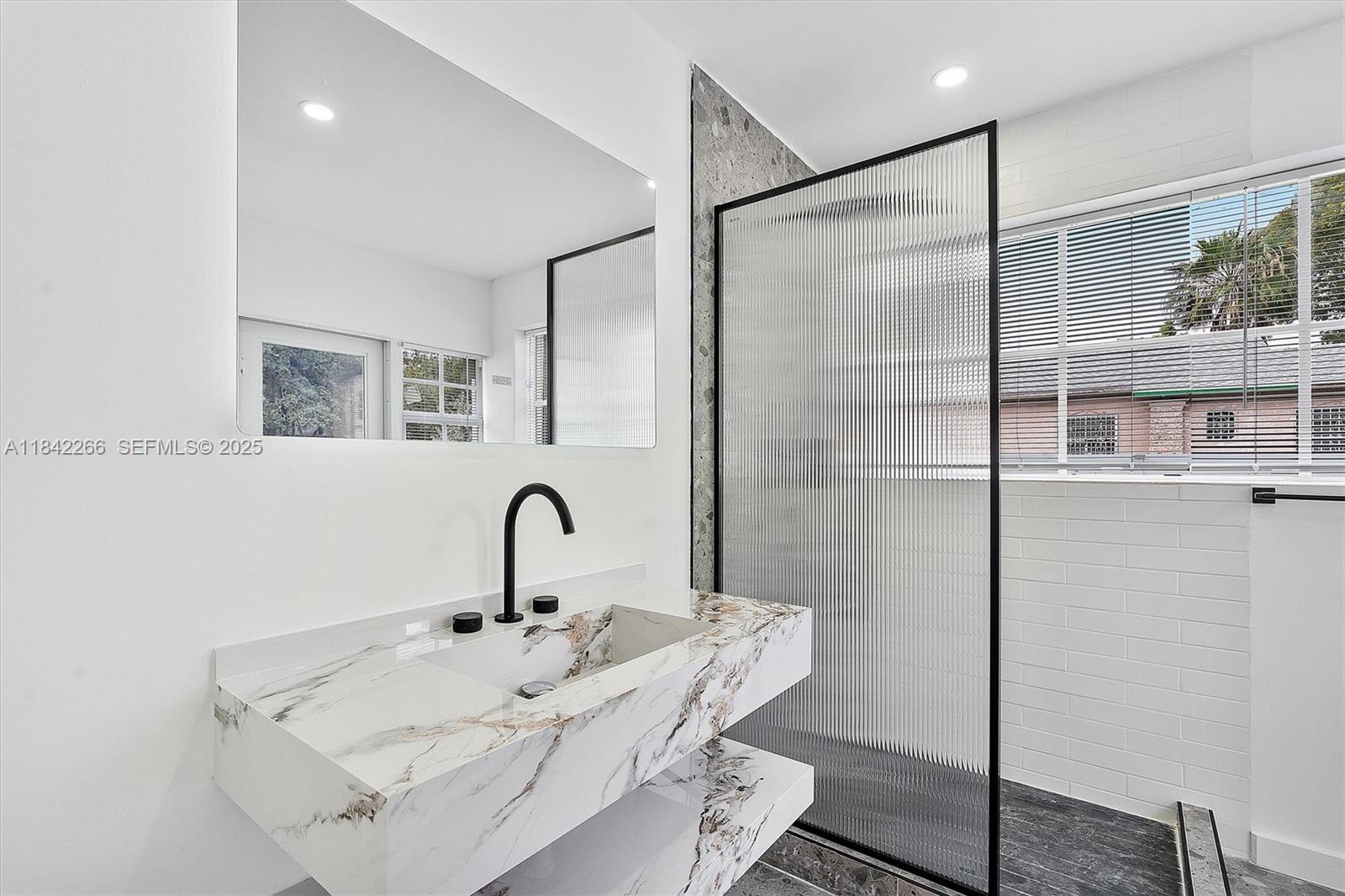 58 Northeast 45th Street Miami, FL 33137 - Photo 53 of 55 a very nice looking room with a glass door shower