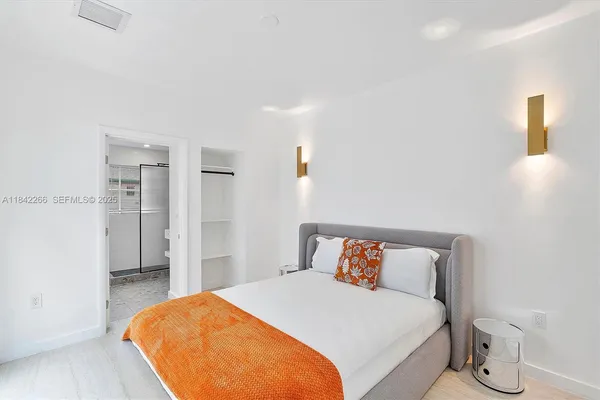 a bedroom with a bed and a lamp
