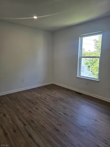 a view of an empty room and wooden floor