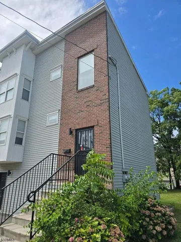 a couple of flower plants in front of house