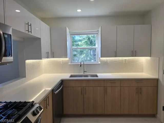a kitchen with wooden cabinets and a stove top oven