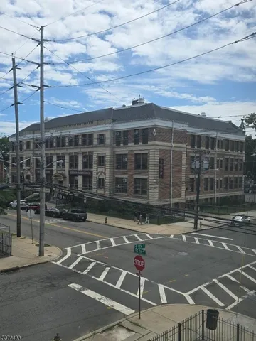 a front view of a building with parking area