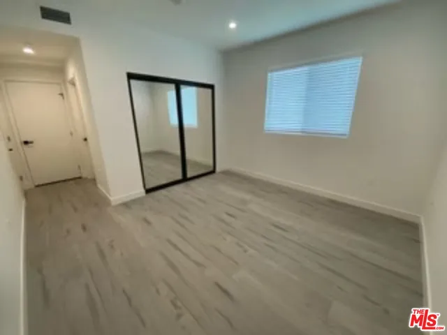 a bathroom with a sink mirror and toilet