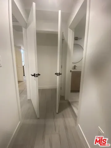 a kitchen with a refrigerator a stove top oven and cabinets