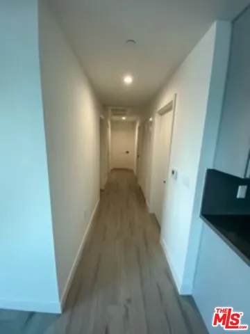 an empty room with wooden floor and mirror