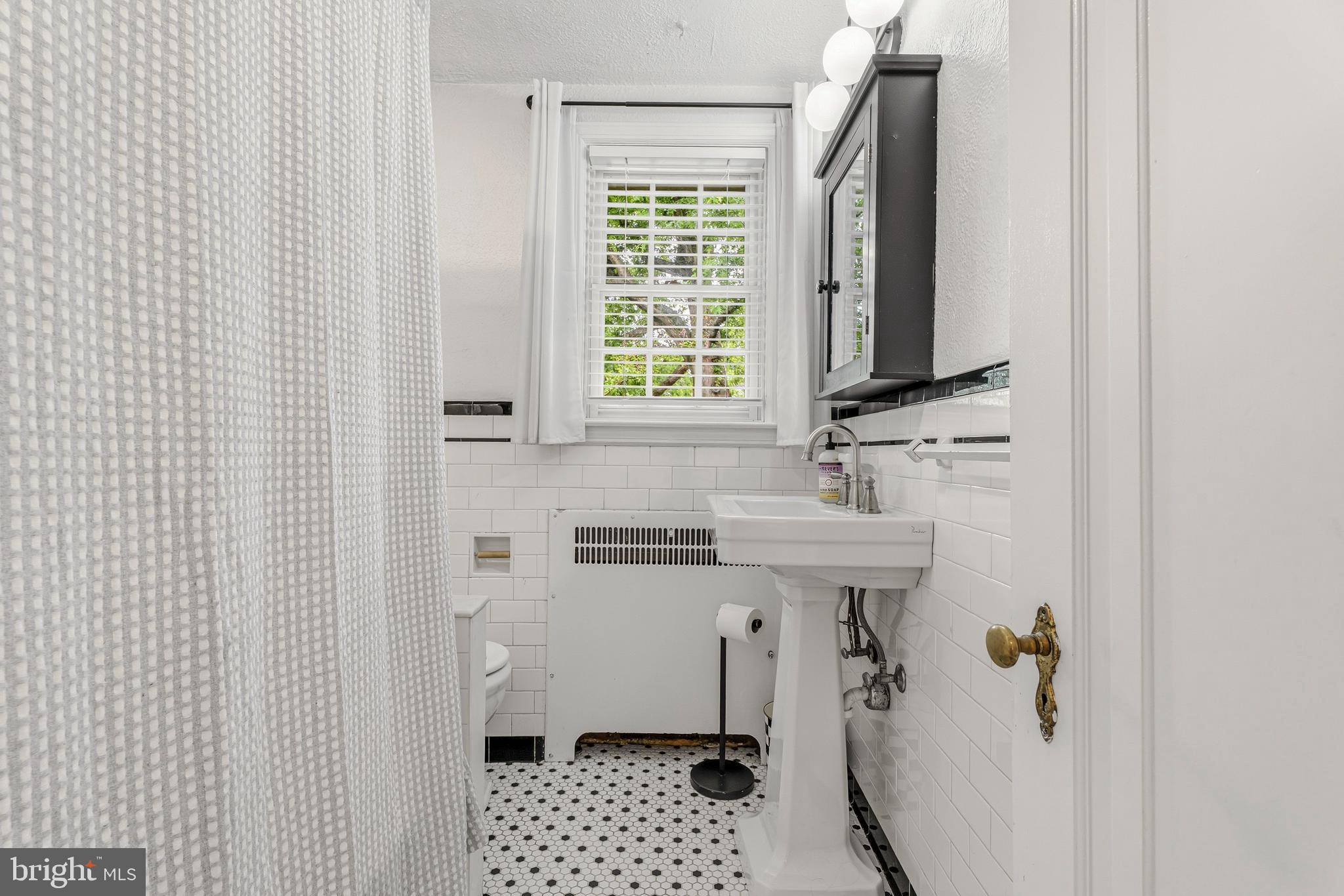 314 Murdock Road Baltimore, MD 21212 - Photo 18 of 42 a bathroom with a sink a toilet and shower