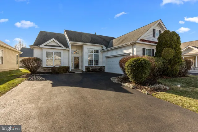 a front view of a house with sitting area