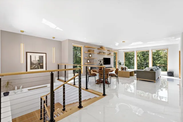 a living room with furniture tv and a large window