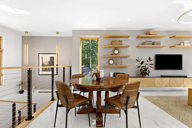 a view of a dining room with furniture and a large window