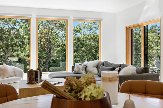 a living room with patio furniture and a large window
