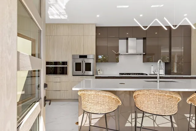 a kitchen with stainless steel appliances granite countertop a stove a sink and a refrigerator