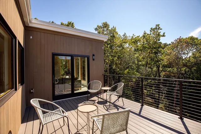 a balcony with table and chairs
