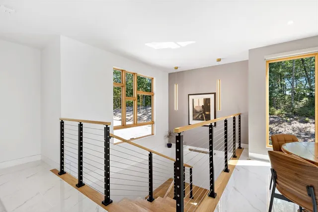 a view of a hallway with furniture and windows