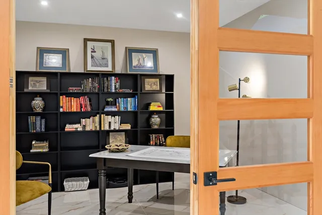 a view of a workspace with bookshelf