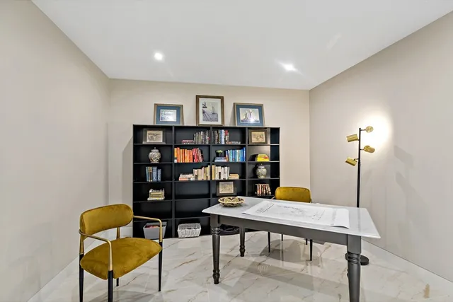 a view of a livingroom with furniture and a bookshelf