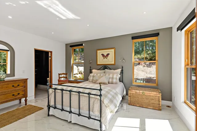 a bedroom with furniture and windows