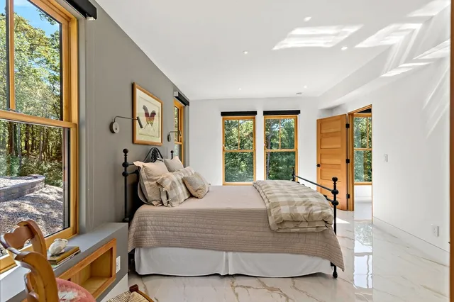 a bedroom with double bed and a large window