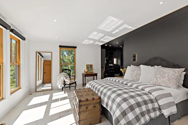 a bathroom with a bathtub shower sink mirror and toilet