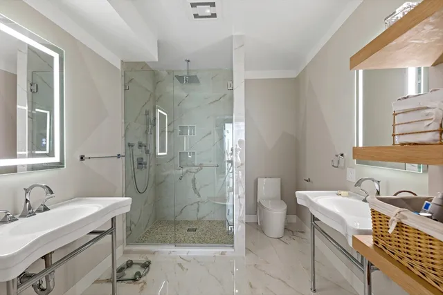 a bathroom with a toilet sink and a mirror