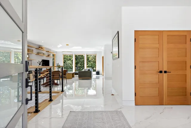 a view of a livingroom with furniture and floor to ceiling window