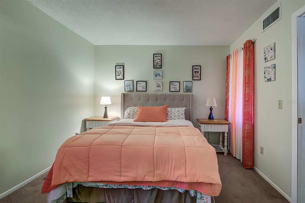 56 Pine Track, Unit 101E Ocala, FL 34472 - Photo 11 of 23 a bedroom with a bed and a closet