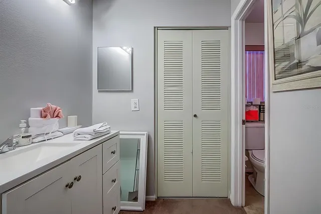 a bathroom with a sink vanity and mirror