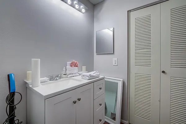 a bathroom with a sink vanity and a mirror