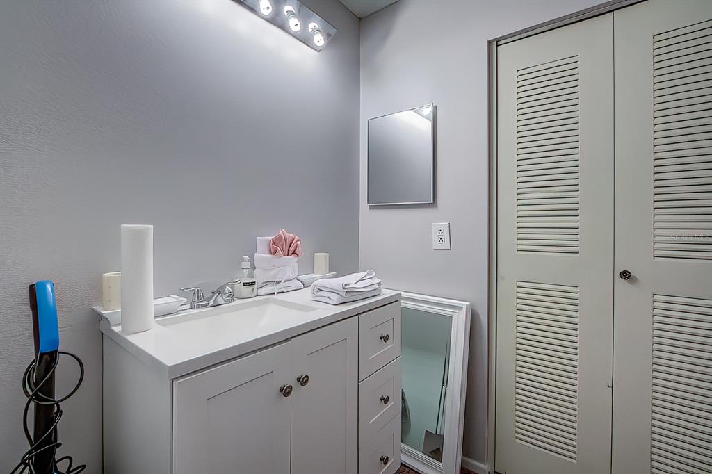56 Pine Track, Unit 101E Ocala, FL 34472 - Photo 13 of 23 a bathroom with a sink vanity and a mirror