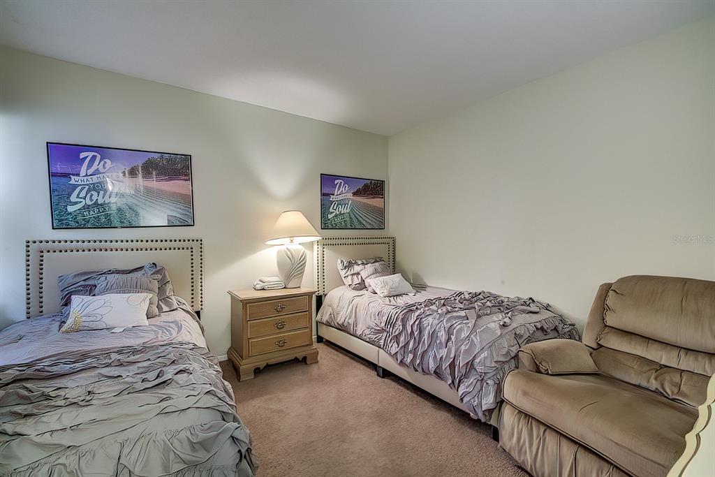 56 Pine Track, Unit 101E Ocala, FL 34472 - Photo 15 of 23 a bedroom with bed and a couch