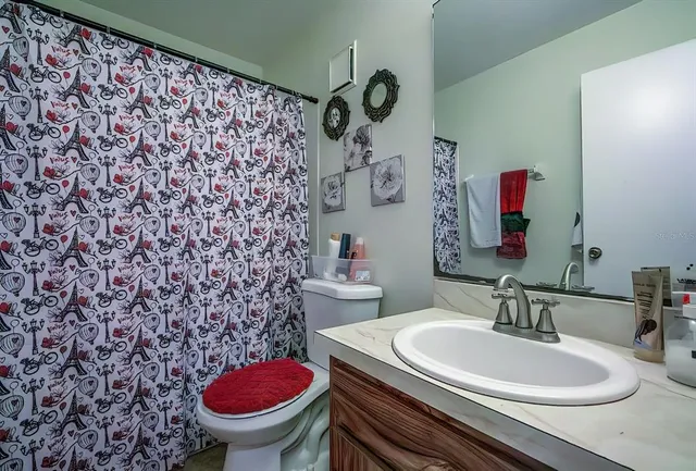 a bathroom with a sink a toilet and a mirror