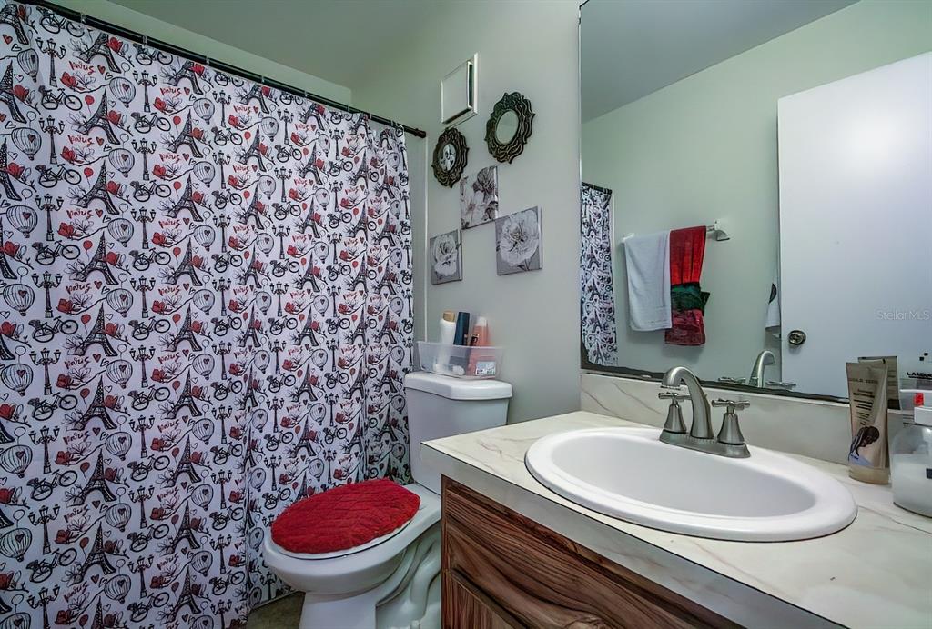 56 Pine Track, Unit 101E Ocala, FL 34472 - Photo 16 of 23 a bathroom with a sink a toilet and a mirror