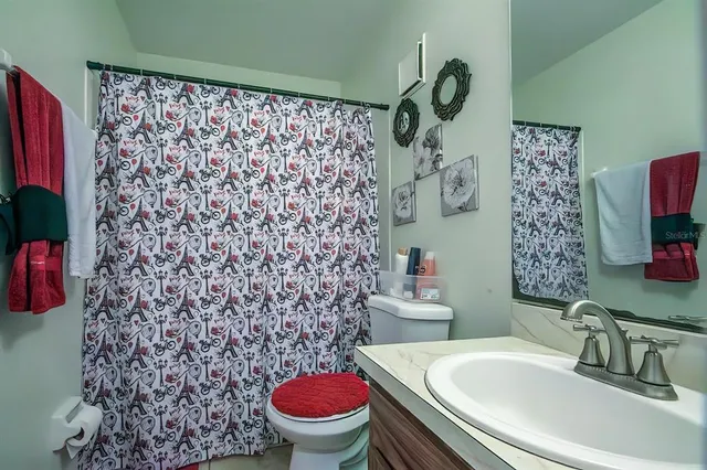 a bathroom with a sink toilet and shower