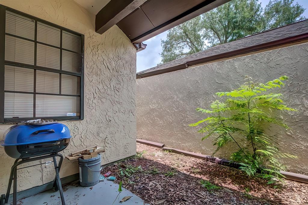 56 Pine Track, Unit 101E Ocala, FL 34472 - Photo 20 of 23 a backyard of a house with lots of green space