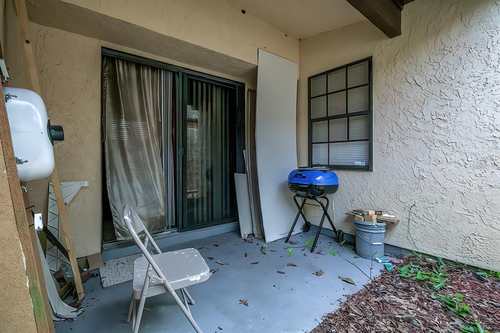 56 Pine Track, Unit 101E Ocala, FL 34472 - Photo 21 of 23 a living room with furniture a rug and a chair