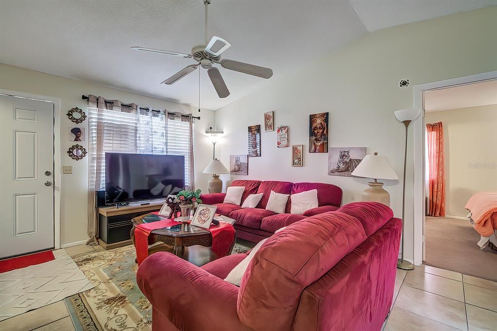 56 Pine Track, Unit 101E Ocala, FL 34472 - Photo 5 of 23 a living room with furniture a flat screen tv and a window
