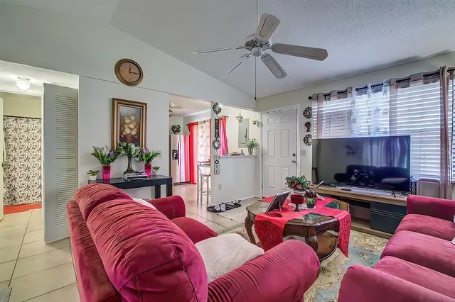 a living room with furniture a fireplace and a window