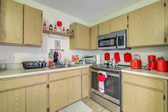 a utility room with sink cabinets and wooden floor