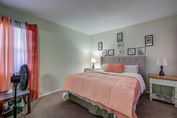 a bedroom with a bed and a window
