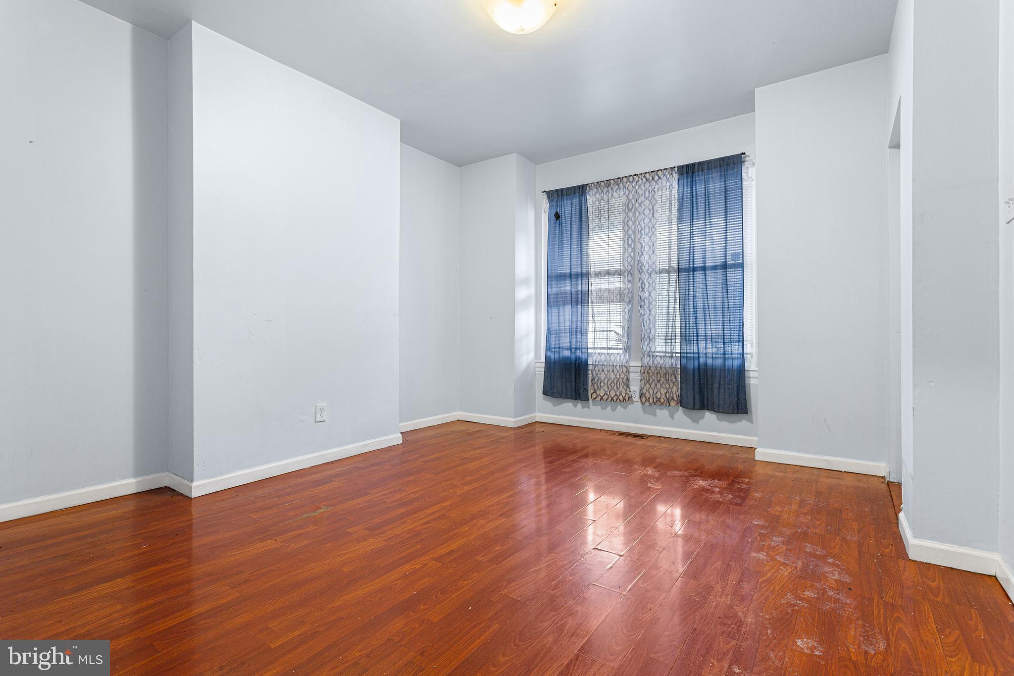 5446 Walnut Street, Unit 1 Philadelphia, PA 19139 - Photo 6 of 15 an empty room with wooden floor and windows