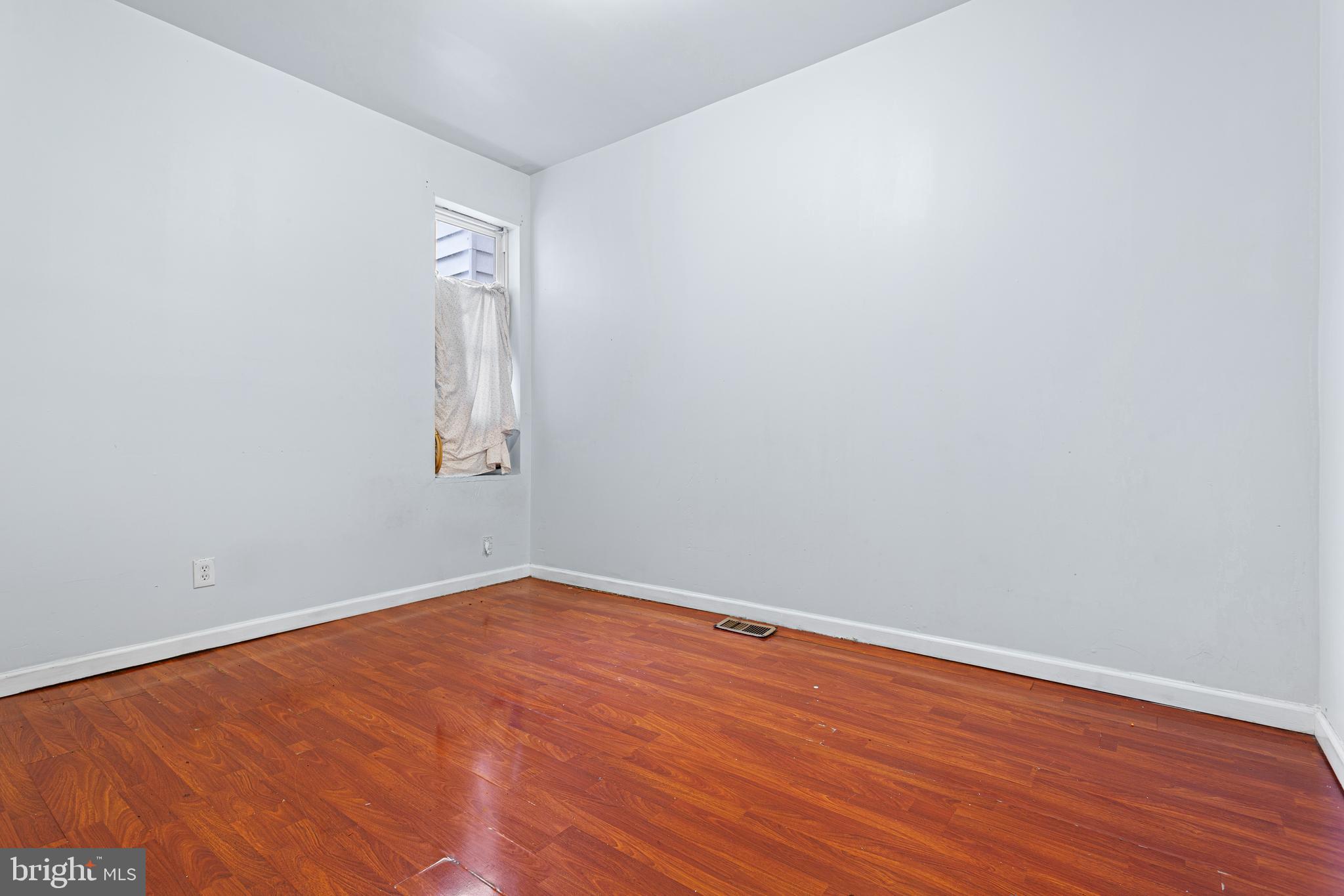 5446 Walnut Street, Unit 1 Philadelphia, PA 19139 - Photo 7 of 15 an empty room with wooden floor and windows