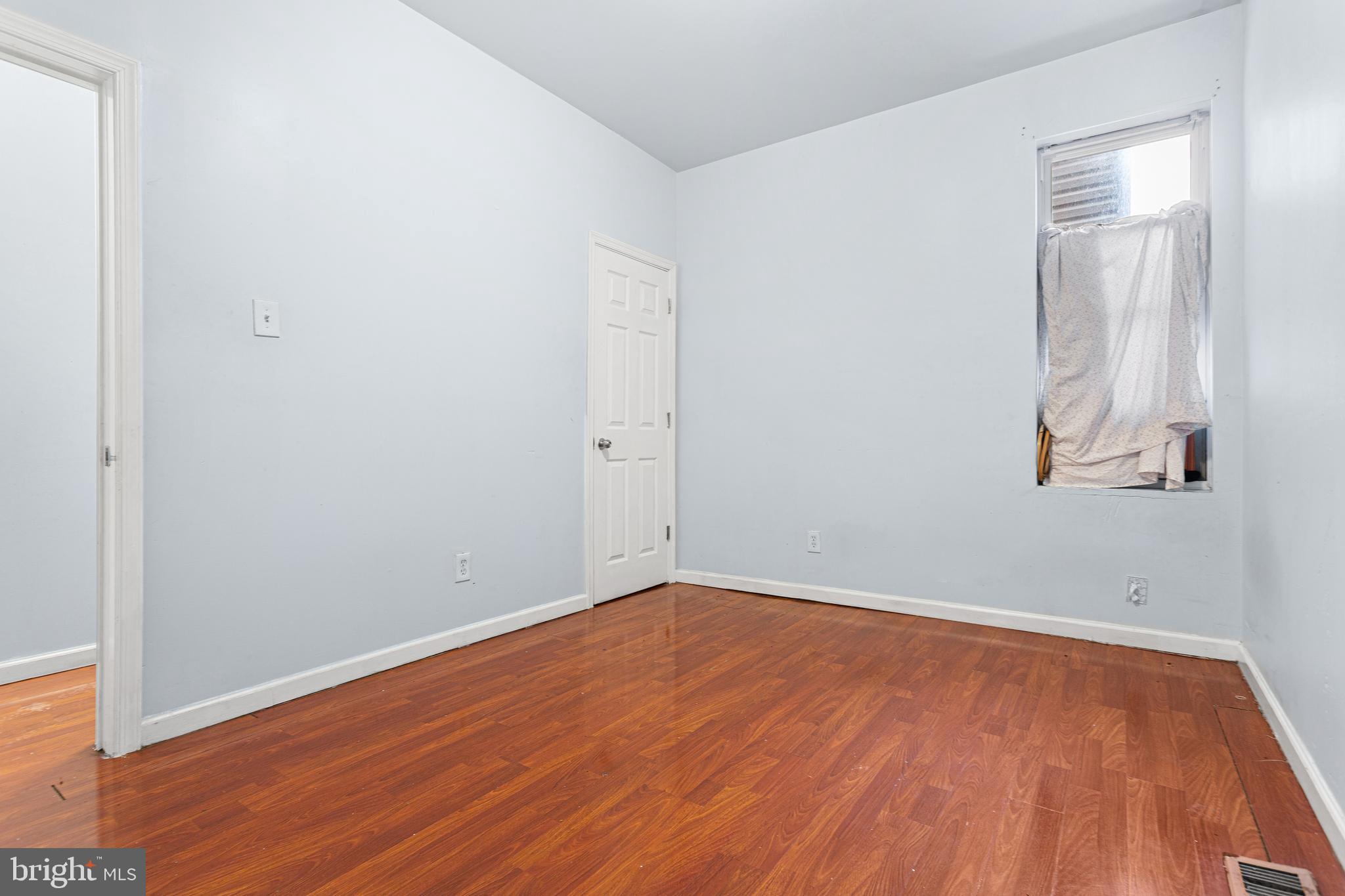 5446 Walnut Street, Unit 1 Philadelphia, PA 19139 - Photo 8 of 15 an empty room with wooden floor and windows